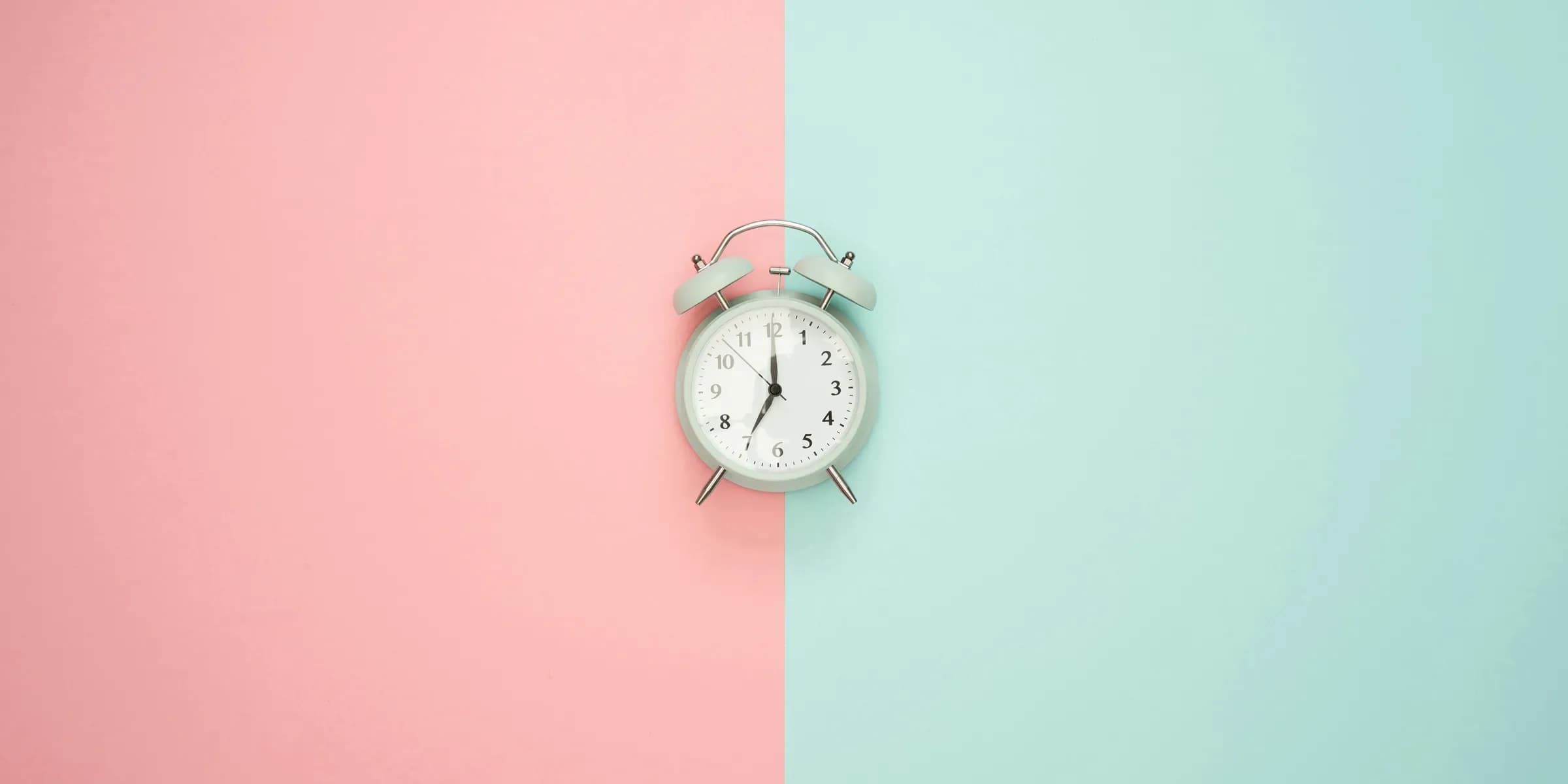 Eine klassische Uhr platziert auf einem zweifarbigen Hintergrund