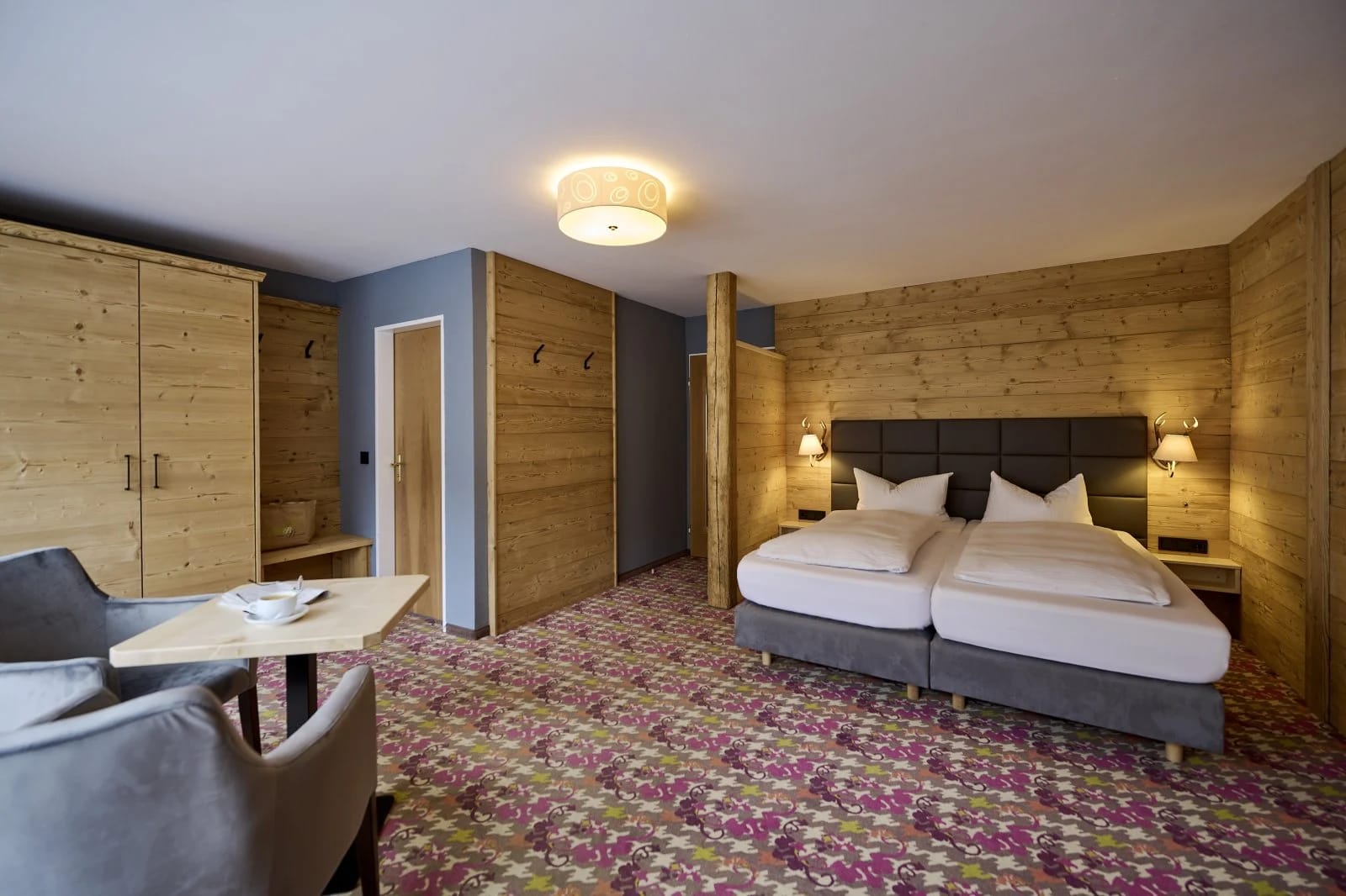 Junior Suite mit Doppelbett, Sitzecke und Holzwänden