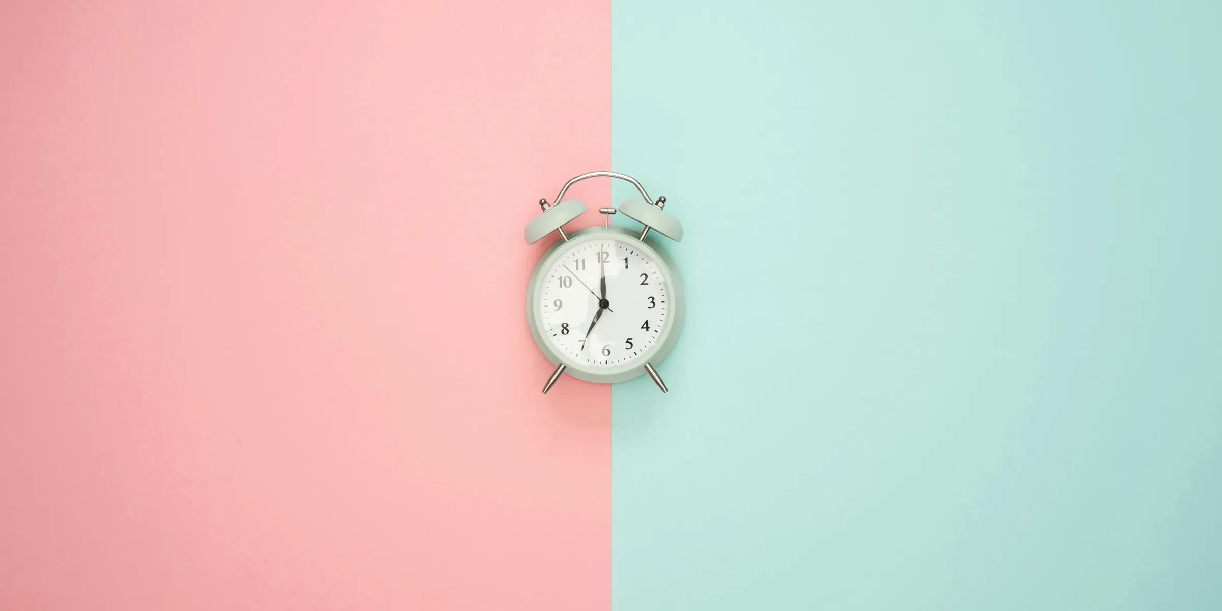 Eine klassische Uhr platziert auf einem zweifarbigen Hintergrund
