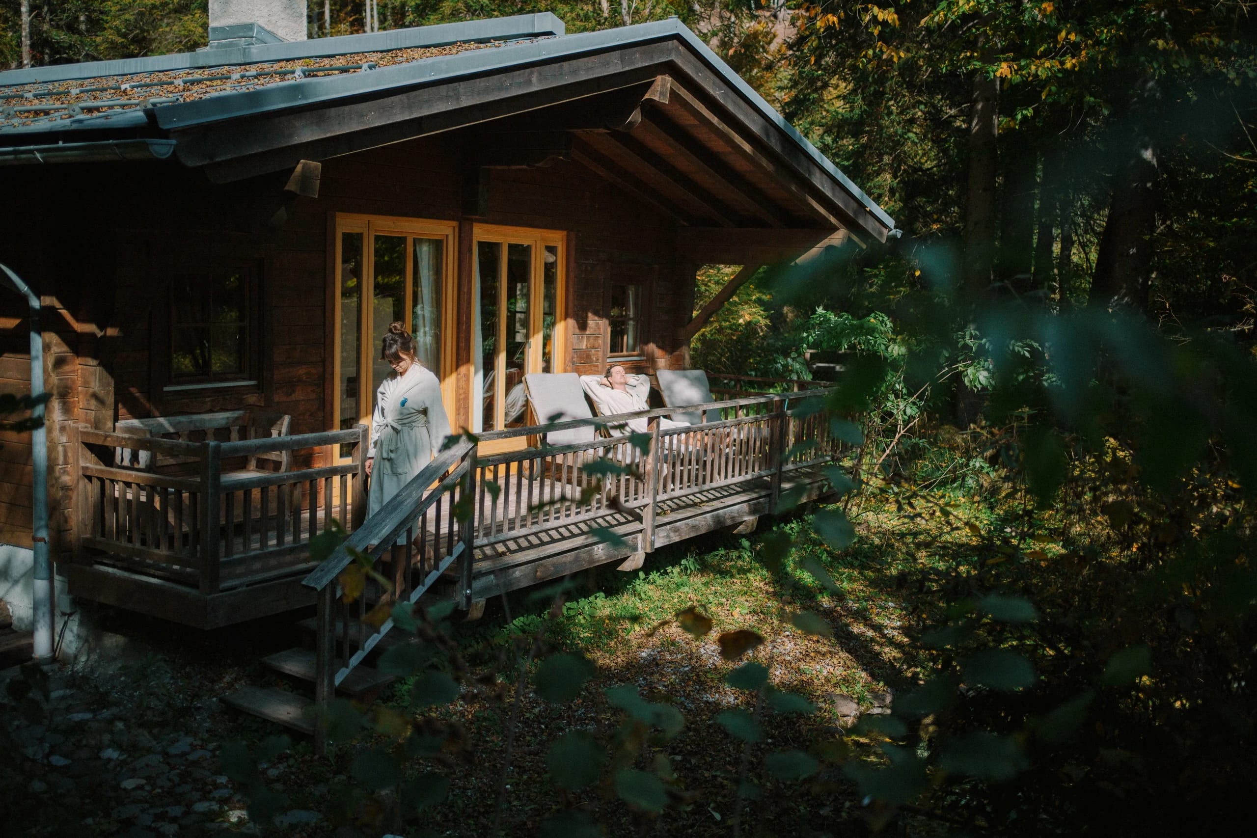 Hölzerne Saunahütte mit Veranda mitten im Wald
